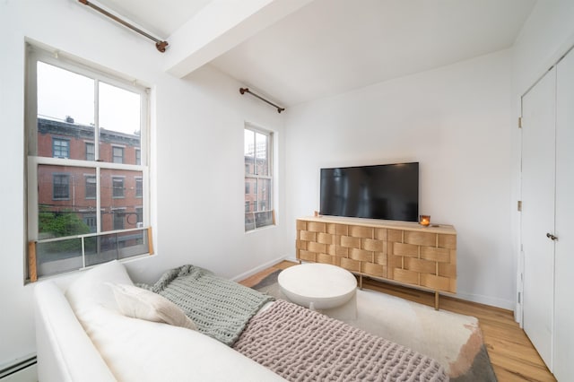 213 8th St, Jersey City, NJ 07302 - living room featuring a baseboard heating unit, wood finished floors, and beam ceiling