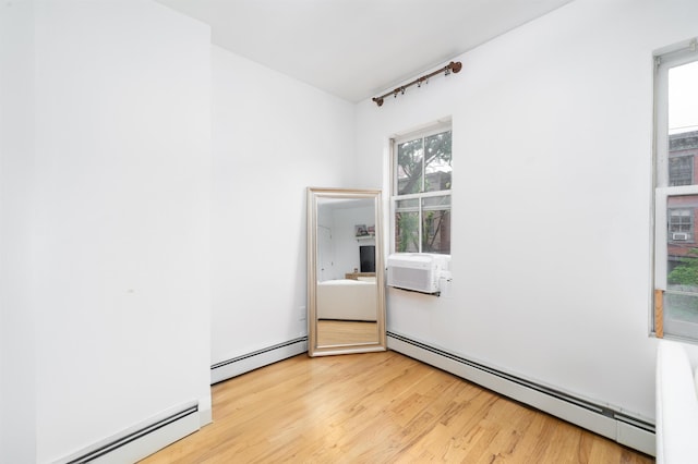 213 8th St, Jersey City, NJ 07302 - spare room with a baseboard heating unit and light wood-style flooring