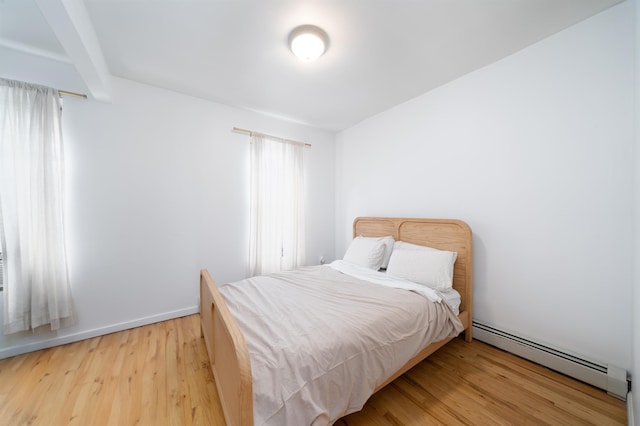 213 8th St, Jersey City, NJ 07302 - bedroom featuring a baseboard radiator and light wood-style floors