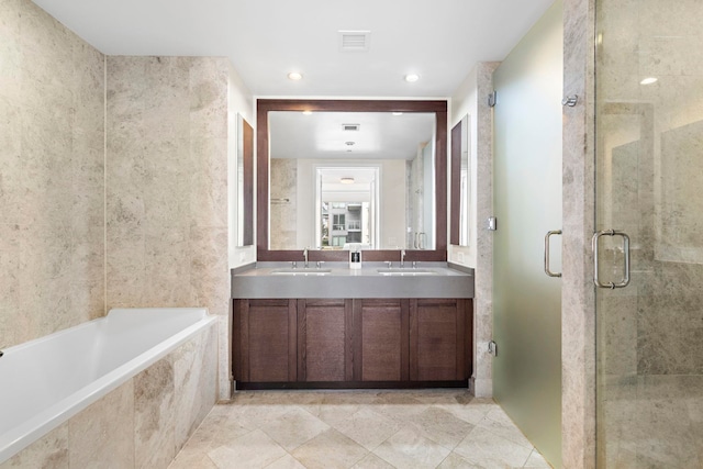 bathroom with visible vents, a shower stall, double vanity, a bath, and a sink