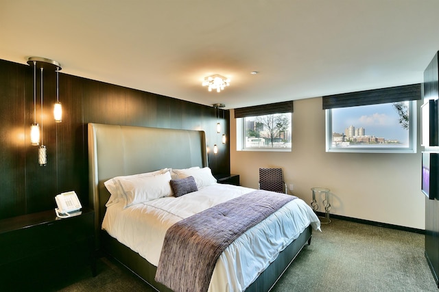 carpeted bedroom featuring baseboards