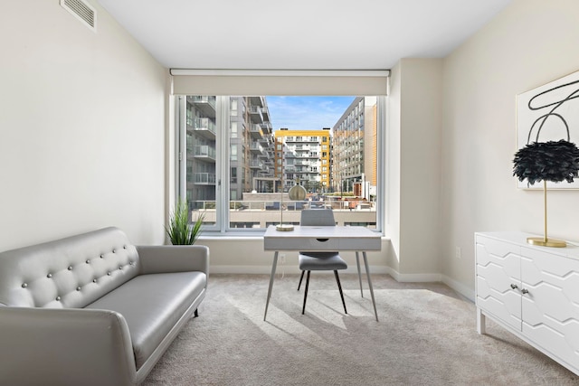 office with a wealth of natural light, visible vents, and carpet floors