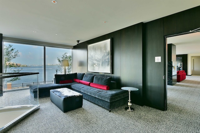 carpeted living room with a water view