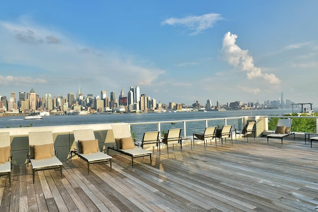 wooden terrace with a view of city and a water view