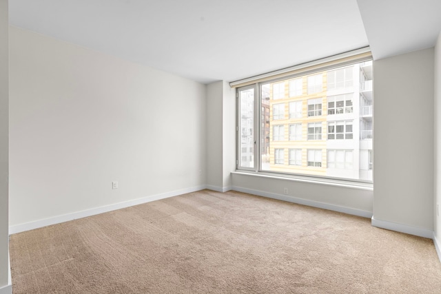 empty room with carpet flooring and baseboards