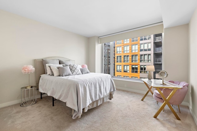 carpeted bedroom with baseboards