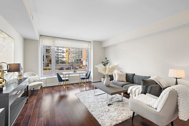 living area featuring dark wood finished floors and baseboards