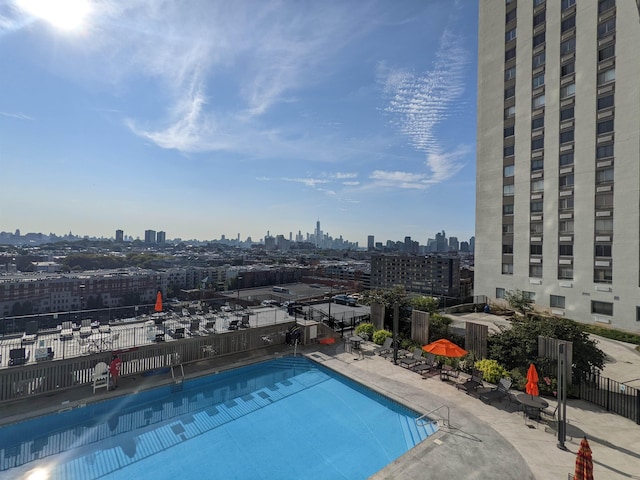 100 Manhattan Ave Unit 1217, Union City, NJ 07087 - community pool featuring fence, a skyline view, and a patio