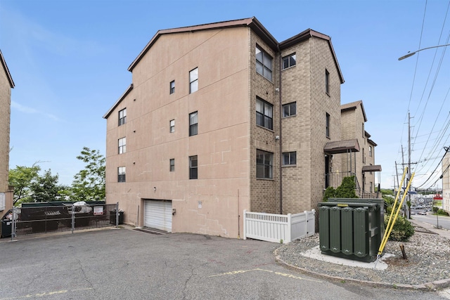 6601 Granton Ave Unit B1, North Bergen, NJ 07047 - view of building exterior featuring driveway and a garage
