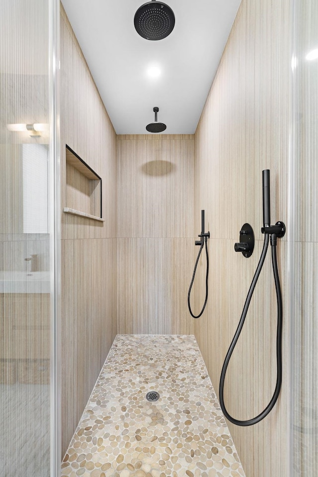 interior details featuring tiled shower