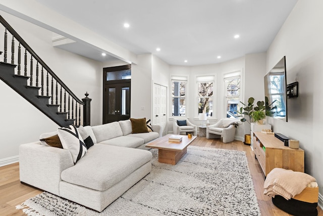 living area featuring recessed lighting, stairway, baseboards, and wood finished floors