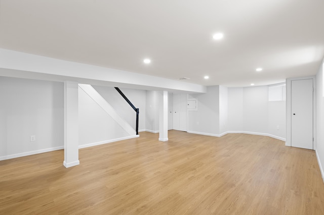 finished below grade area featuring recessed lighting, light wood-type flooring, and baseboards