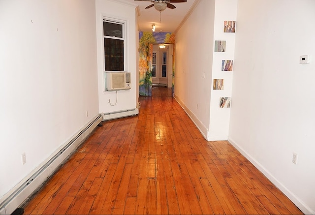 hall with cooling unit, ornamental molding, baseboard heating, and light hardwood / wood-style flooring