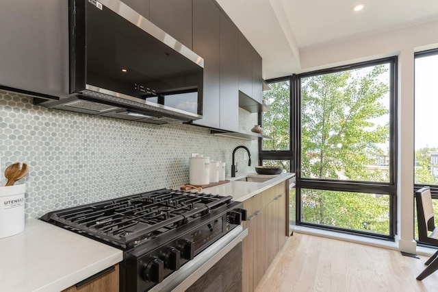 433 Central Ave Unit 3A, Jersey City, NJ 07307 - kitchen with range with gas stovetop, stainless steel microwave, light countertops, and tasteful backsplash
