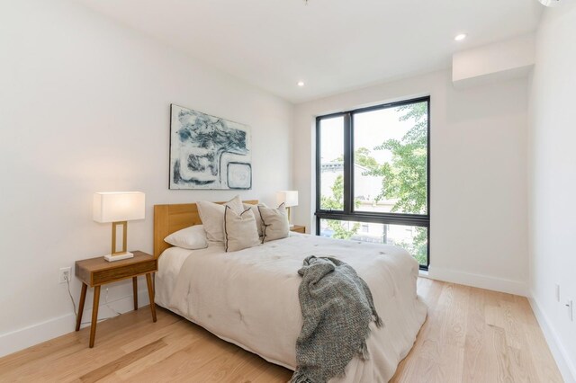 433 Central Ave Unit 3A, Jersey City, NJ 07307 - bedroom featuring multiple windows, light wood finished floors, and recessed lighting