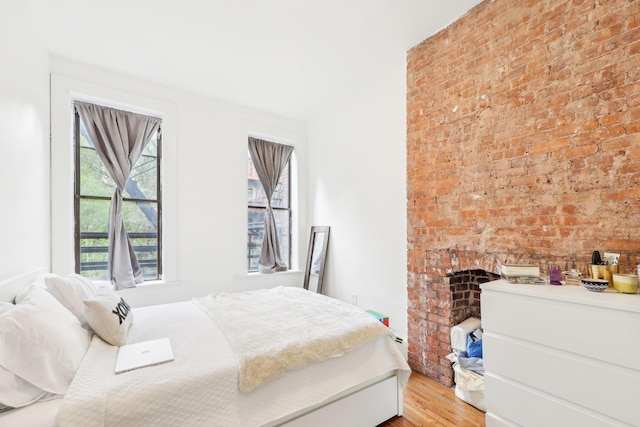 300 Barrow St, Jersey City, NJ 07302 - bedroom with light wood-style floors and a fireplace