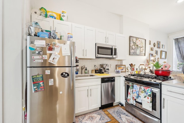 300 Barrow St, Jersey City, NJ 07302 - kitchen featuring a sink, backsplash, light countertops, and appliances with stainless steel finishes