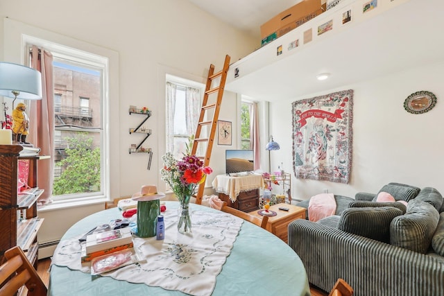 300 Barrow St, Jersey City, NJ 07302 - dining area with wood finished floors and a baseboard heating unit