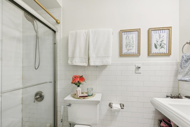 300 Barrow St, Jersey City, NJ 07302 - full bath featuring toilet, tile walls, a shower stall, and a wainscoted wall