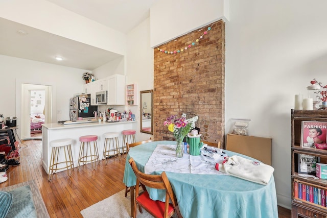 300 Barrow St, Jersey City, NJ 07302 - dining area featuring light wood finished floors and a towering ceiling