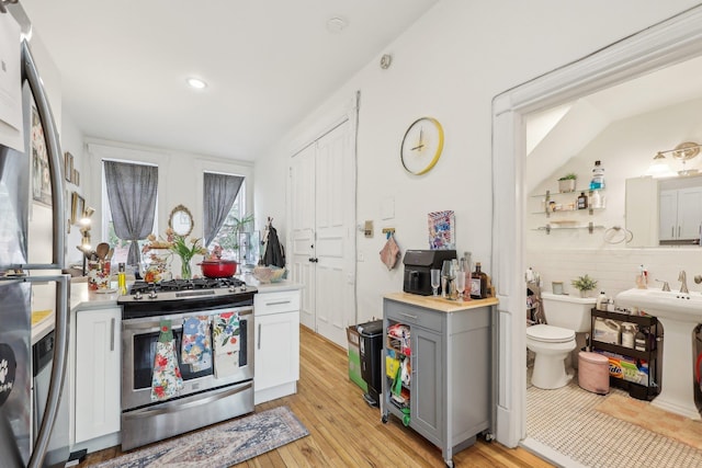 300 Barrow St, Jersey City, NJ 07302 - kitchen with light wood finished floors, gray cabinetry, appliances with stainless steel finishes, and light countertops