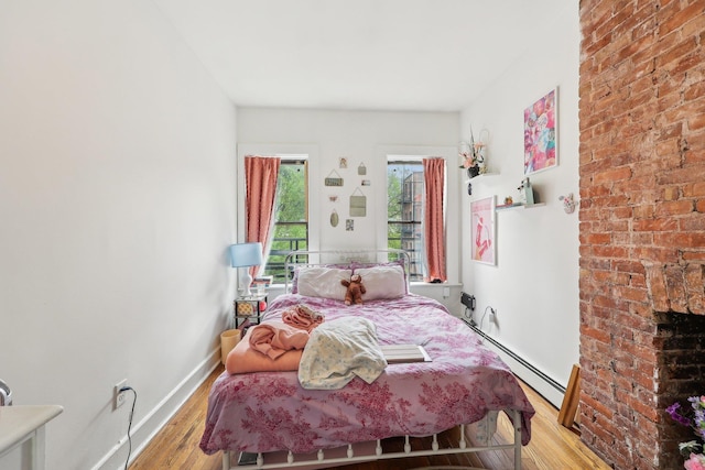 300 Barrow St, Jersey City, NJ 07302 - bedroom with baseboards, light wood finished floors, and baseboard heating
