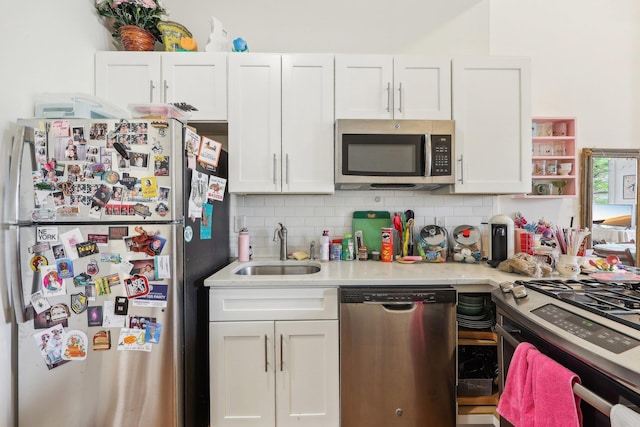 300 Barrow St, Jersey City, NJ 07302 - kitchen featuring stainless steel appliances, tasteful backsplash, a sink, light countertops, and white cabinets