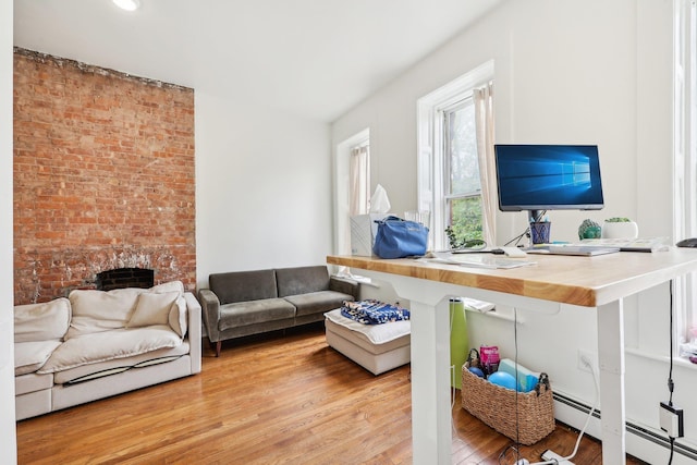 300 Barrow St, Jersey City, NJ 07302 - living area with a brick fireplace, a baseboard radiator, and wood finished floors