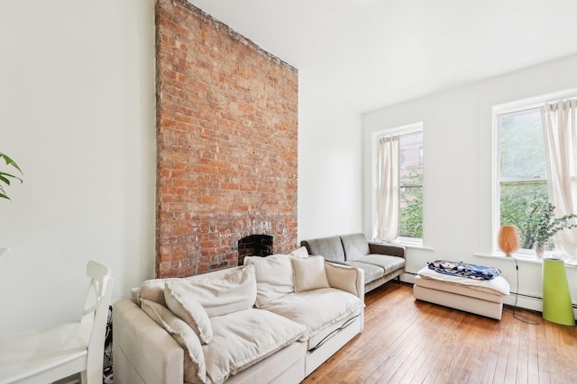 300 Barrow St, Jersey City, NJ 07302 - living area featuring a fireplace, a baseboard radiator, and wood-type flooring