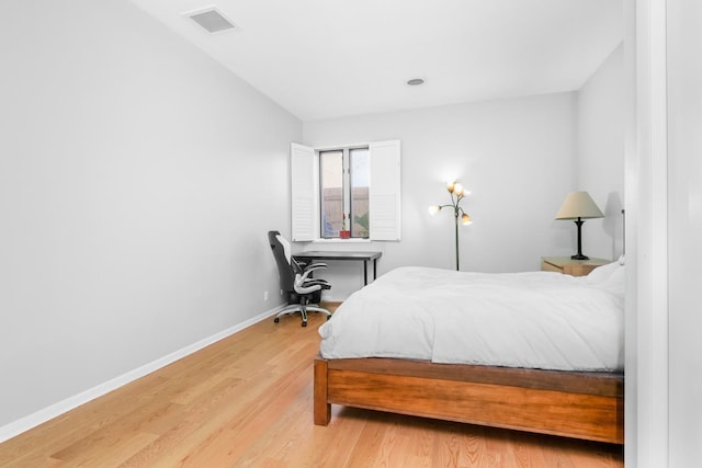 bedroom with visible vents, baseboards, and light wood-style flooring