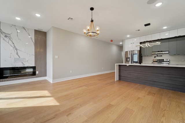 313 Lembeck Ave Unit 1, Jersey City, NJ 07305 - kitchen featuring stainless steel fridge with ice dispenser, modern cabinets, a chandelier, light countertops, and recessed lighting