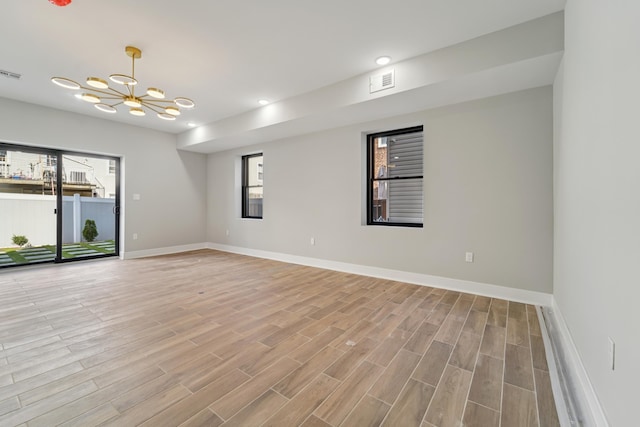313 Lembeck Ave Unit 1, Jersey City, NJ 07305 - unfurnished room featuring healthy amount of natural light, a chandelier, light wood-style flooring, and recessed lighting