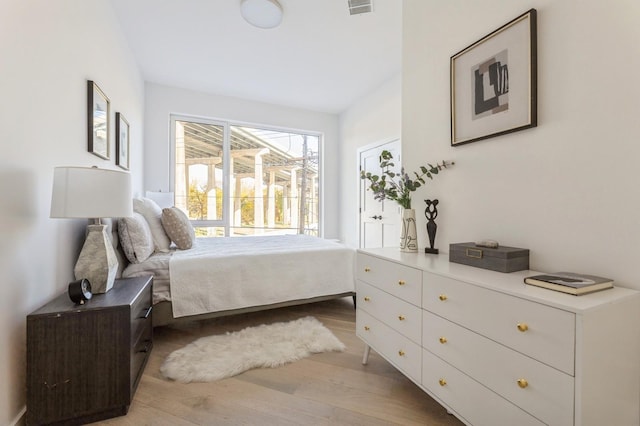 bedroom featuring light wood-type flooring and visible vents