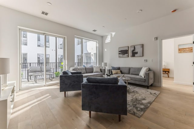 living area featuring visible vents and light wood-type flooring