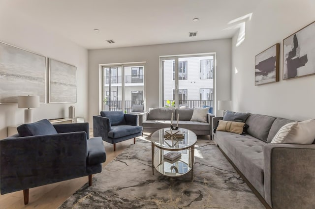 living area with wood finished floors and visible vents