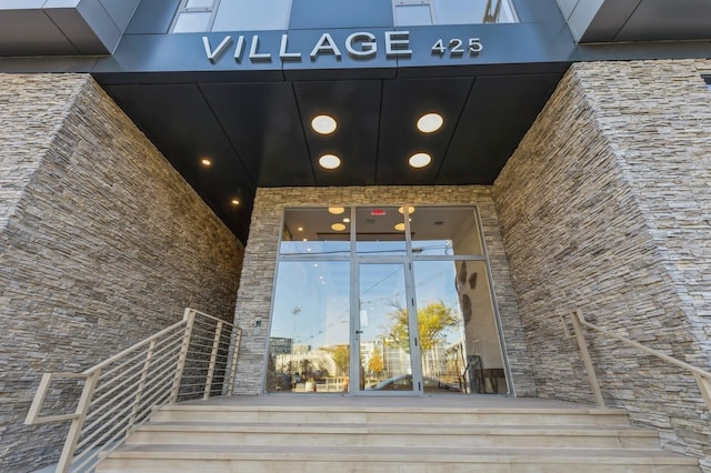entrance to property featuring stone siding