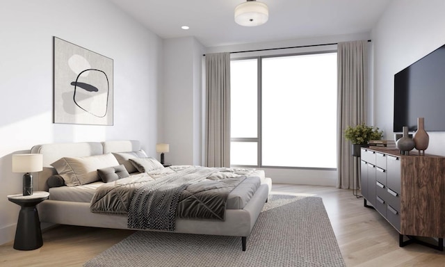 bedroom with light wood-style floors and recessed lighting