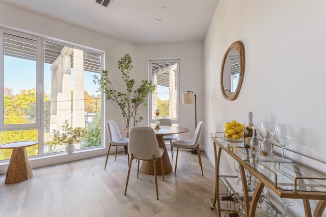 dining space with plenty of natural light and wood finished floors
