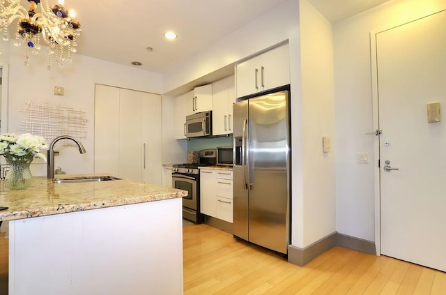 4 Beacon Way Unit 1110, Jersey City, NJ 07304 - kitchen featuring appliances with stainless steel finishes, a sink, light wood-style floors, white cabinetry, and recessed lighting