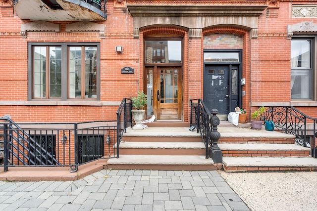 property entrance featuring brick siding