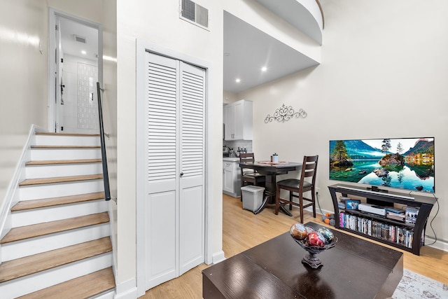 stairs with recessed lighting, visible vents, baseboards, and wood finished floors