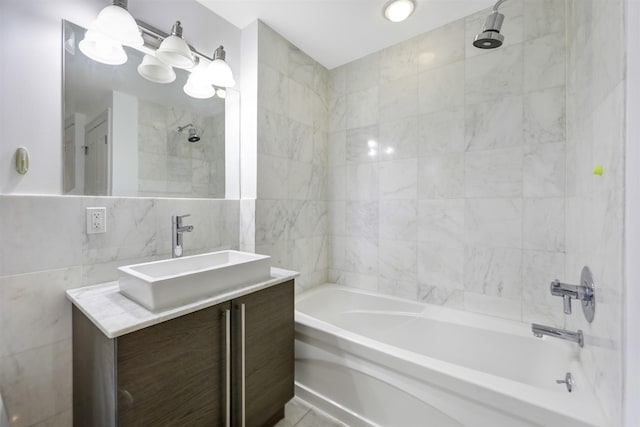 full bath with tile walls, shower / washtub combination, and vanity