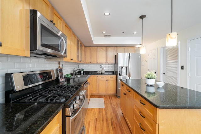 721 Madison St Unit 4N, Hoboken, NJ 07030 - kitchen featuring appliances with stainless steel finishes, light wood-style flooring, decorative backsplash, a center island, and recessed lighting