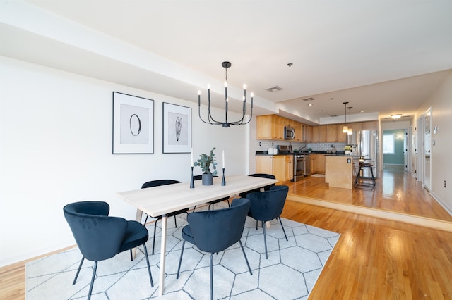 721 Madison St Unit 4N, Hoboken, NJ 07030 - dining area featuring light wood finished floors and a chandelier
