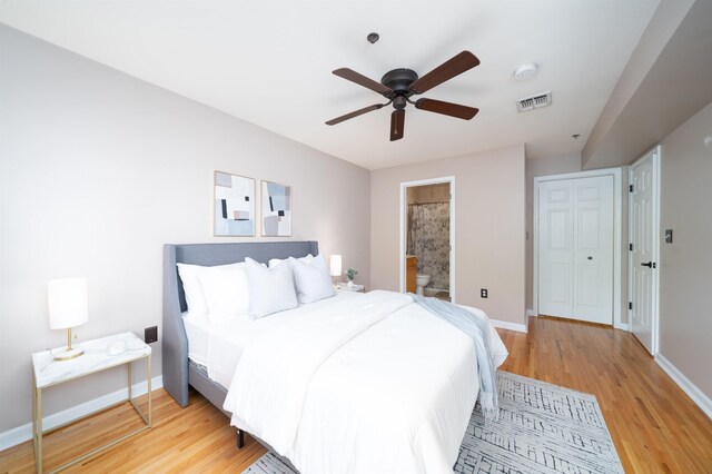 721 Madison St Unit 4N, Hoboken, NJ 07030 - bedroom with light wood-style flooring, ensuite bathroom, and a ceiling fan