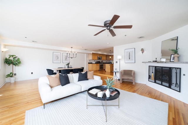721 Madison St Unit 4N, Hoboken, NJ 07030 - living room with light wood finished floors, ceiling fan, and a chandelier
