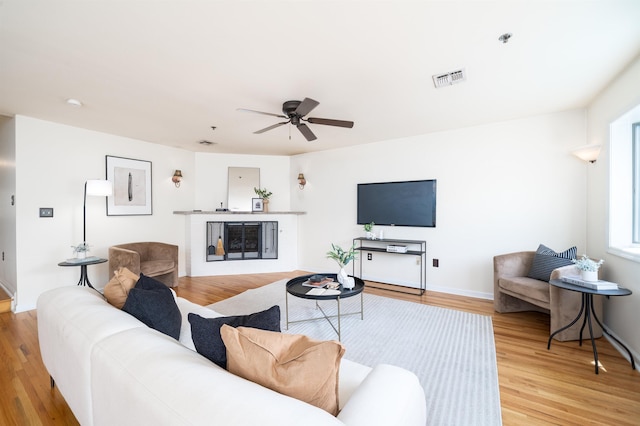 721 Madison St Unit 4N, Hoboken, NJ 07030 - living area with light wood finished floors, ceiling fan, and a glass covered fireplace