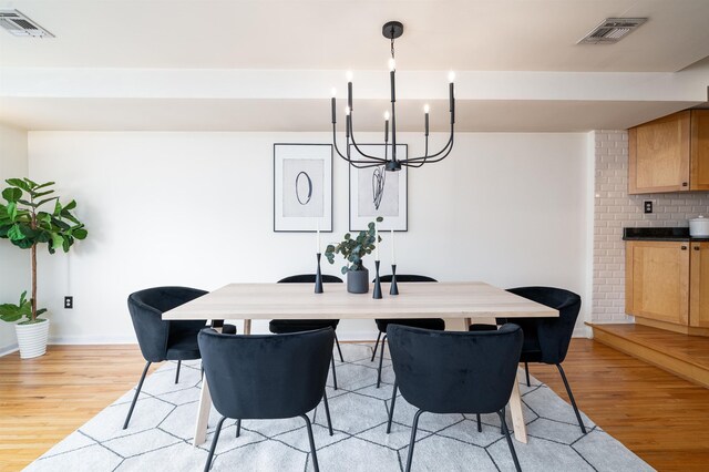 721 Madison St Unit 4N, Hoboken, NJ 07030 - dining space with light wood-style floors and a chandelier