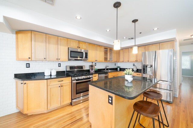 721 Madison St Unit 4N, Hoboken, NJ 07030 - kitchen featuring stainless steel appliances, light brown cabinets, light wood finished floors, and a kitchen breakfast bar