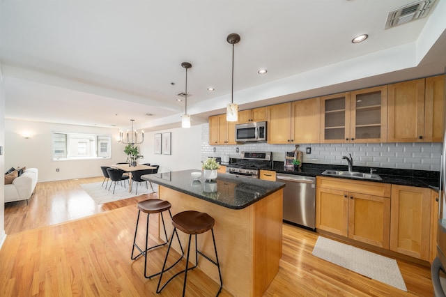 721 Madison St Unit 4N, Hoboken, NJ 07030 - kitchen featuring stainless steel appliances, light wood-style floors, a kitchen island, tasteful backsplash, and recessed lighting